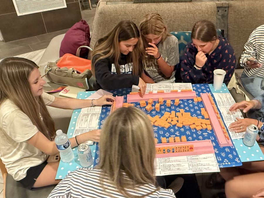 Teens learning to play mahjong together